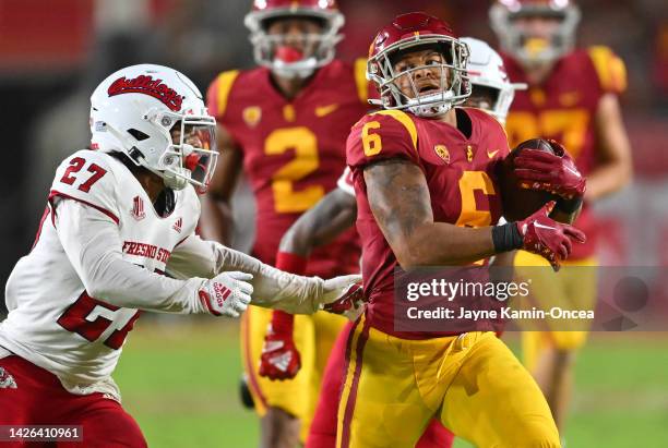 Running back Austin Jones of the USC Trojans gains 44 yards before he is stopped by defensive back LJ Early of the Fresno State Bulldogs in the game...