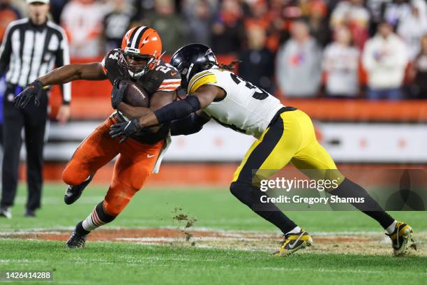 Nick Chubb of the Cleveland Browns rushes ahead of Terrell Edmunds of the Pittsburgh Steelers during the third quarter at FirstEnergy Stadium on...