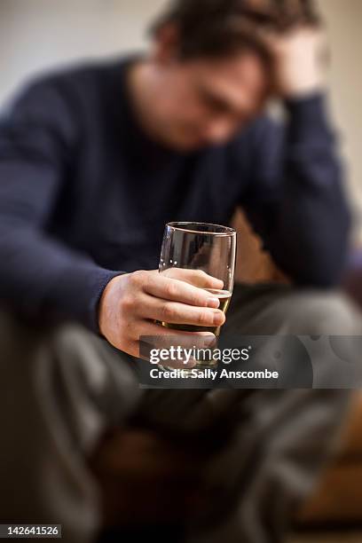 man drinking pint of lager - alcohol dependency stock pictures, royalty-free photos & images