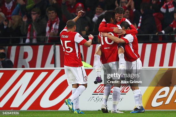 Nicolai Mueller of Mainz celebrates his team's third goal with team mates during the Bundesliga match between between FSV Mainz 05 and 1. FC Koeln at...