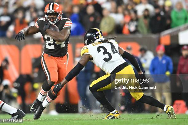 Nick Chubb of the Cleveland Browns rushes ahead of Terrell Edmunds of the Pittsburgh Steelers during the second half at FirstEnergy Stadium on...