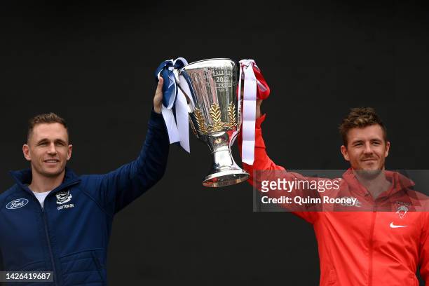 Joel Selwood of the Geelong Cats and Luke Parker of the Sydney Swans hold aloft the 2022 Premiership Trophy during the 2022 AFL Grand Final Parade on...