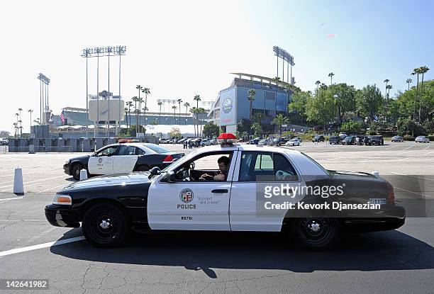 Los Angeles Police Department officers patrol in squad car the parking lot of Dodger Stadium prior to the home opener aginst the Pittsburgh Pirates...