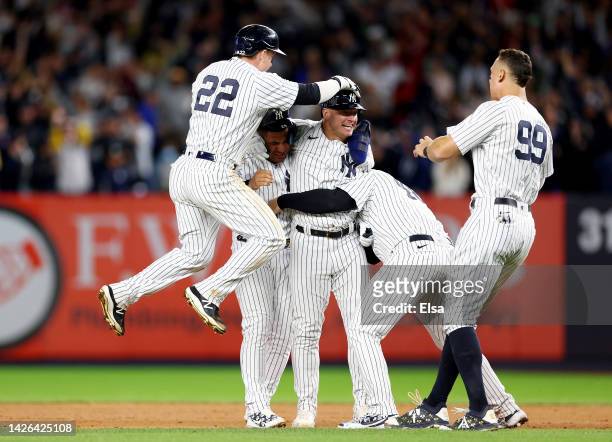 Josh Donaldson of the New York Yankees is congratulated by teammates Harrison Bader,Gleyber Torres,Anthony Rizzo and Aaron Judge after Donaldson...