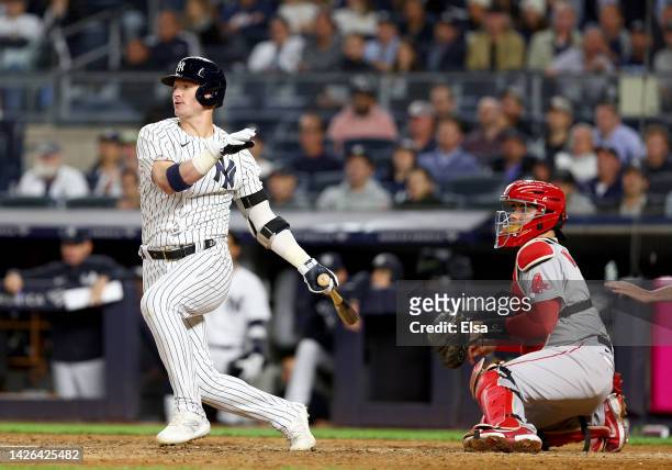 Josh Donaldson of the New York Yankees drives in the game winning run in the 10th inning as Reese McGuire of the Boston Red Sox defends at Yankee...