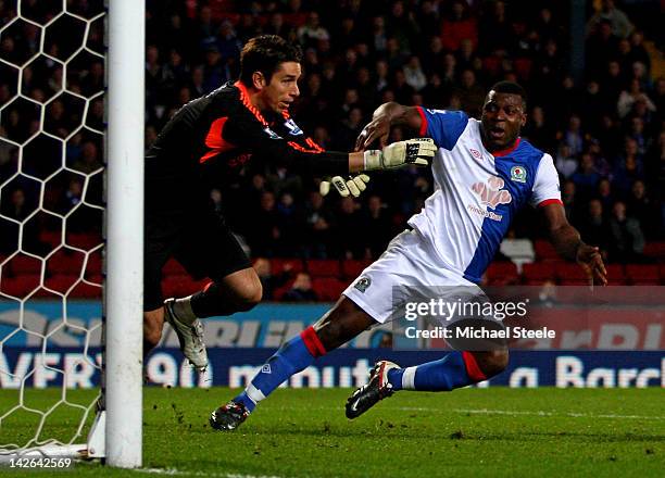 Brad Jones of Liverpool brings down Yakubu of Blackburn Rovers to concede a penalty during the Barclays Premier League match between Blackburn Rovers...