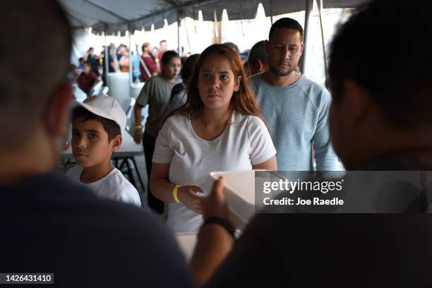 Jheanpiere Contreras, Genesis Contreras, and Daniel Soto, who two days ago arrived from Venezuela after crossing the U.S. Border from Mexico, wait in...