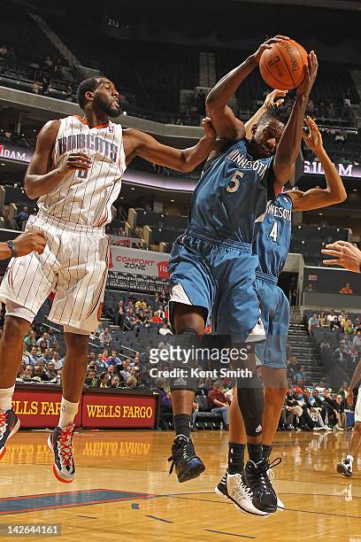 Martell Webster of the Minnesota Timberwolves grabs the rebound against D.J. White of the Charlotte Bobcats on March 28, 2012 at the Time Warner...