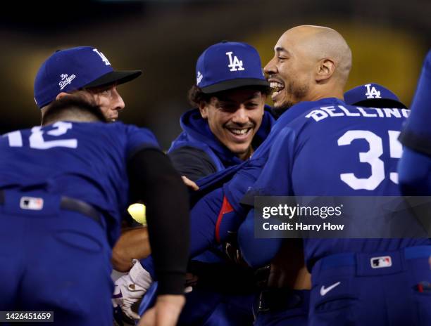 Mookie Betts of the Los Angeles Dodgers celebrates his walk off single with Miguel Vargas and Cody Bellinger, for a 3-2 win over the Arizona...