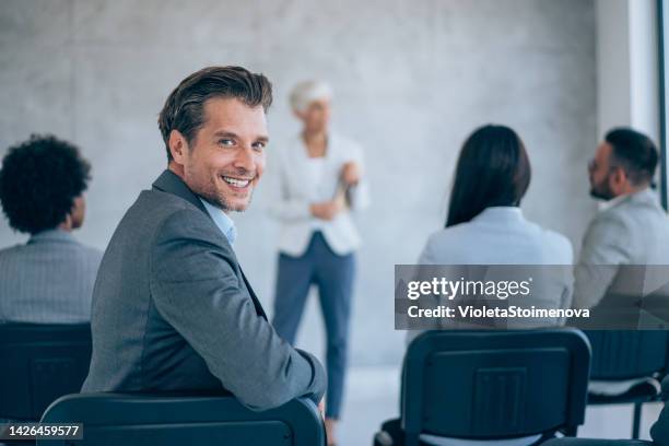 confident businessman attending a seminar. - boss over shoulder stock pictures, royalty-free photos & images