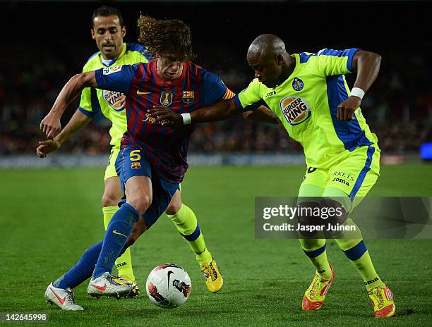 Carles Puyol of FC Barcelona duels for the ball with Abdelaziz Barrada and Nicolas Fedor during the La Liga match between FC Barcelona and Getafe CF...