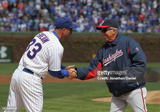 Manager Dale Sveum of the Chicago Cubs shakes hands with manager Davey Johnson of the Washington Nationals before the opening day game at Wrigley...