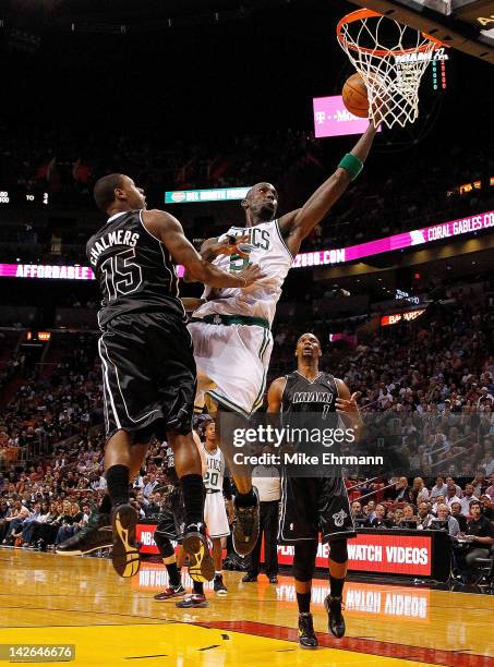 Kevin Garnett of the Boston Celtics drives on Mario Chalmers of the Miami Heat during a game at American Airlines Arena on April 10, 2012 in Miami,...