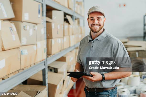 ecommerce, logistics and supply chain with a man courier working with a tablet in a distribution warehouse, factory or plant. delivery, stock and shipping cargo in the export and import industry - value chain stock pictures, royalty-free photos & images