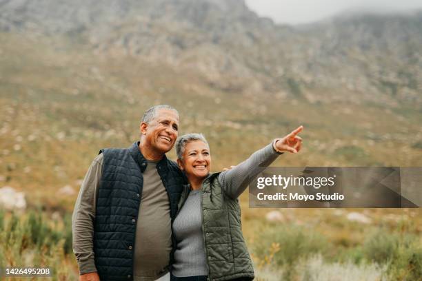 hiking, couple and view with a senior man and woman in nature for a hike and enjoying the outdoor adventure. elderly married people exploring a natural environment in the mountain or wilderness - conveyor belt point of view stockfoto's en -beelden