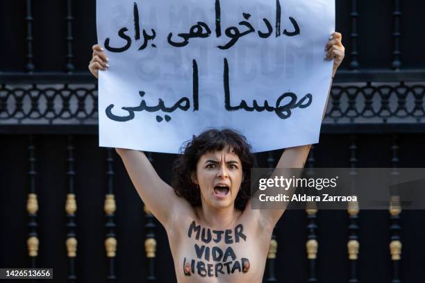 Member of the women's rights organization Femen protests in front of the Iranian Embassy on September 23, 2022 in Madrid, Spain. Femen activists are...