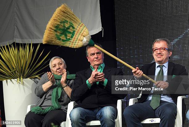 Roberto MAroni waves his broom as Manuela Dal Lago and Roberto Calderol look on during the Padania Pride political convention at Expo palace on April...
