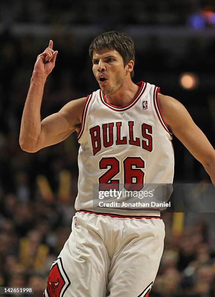 Kyle Korver of the Chicago Bulls turns to the New York Knicks bench and celebrates hitting a three point shot at the United Center on April 10, 2012...
