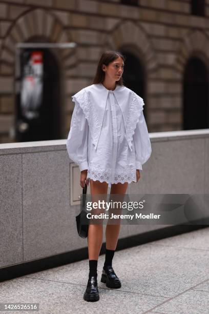 Fashion week guest seen wearing a white dress, outside peter do during New York Fashion Week on September 13, 2022 in New York City.