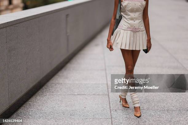 Fashion week guest seen wearing a pleated skirt, outside peter do during New York Fashion Week on September 13, 2022 in New York C.