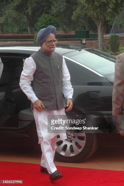 Indian Prime Minister Manmohan Singh steps on a red carpet in New Delhi.