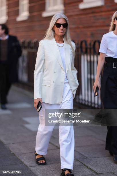 Fashion week guests seen wearing black and white looks, outside molly goddard during London Fashion Week on September 17, 2022 in London, England.
