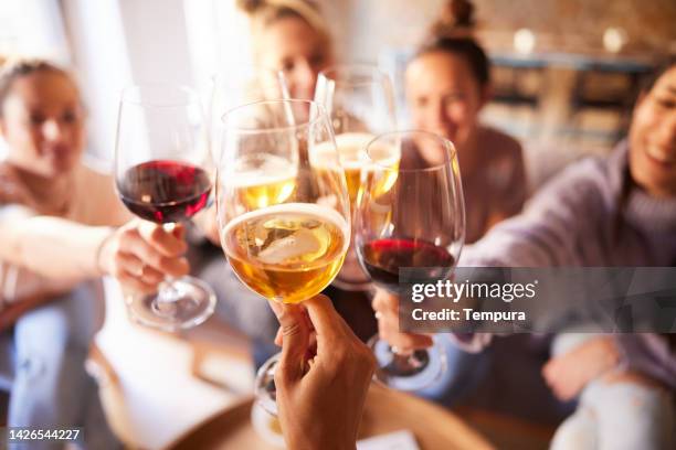 close-up of wine and beer cups. making a toast. - toast stock pictures, royalty-free photos & images