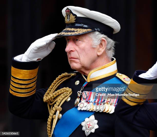 King Charles III salutes his mother Queen Elizabeth II's coffin as he attends the Committal Service for Queen Elizabeth II at St George's Chapel,...