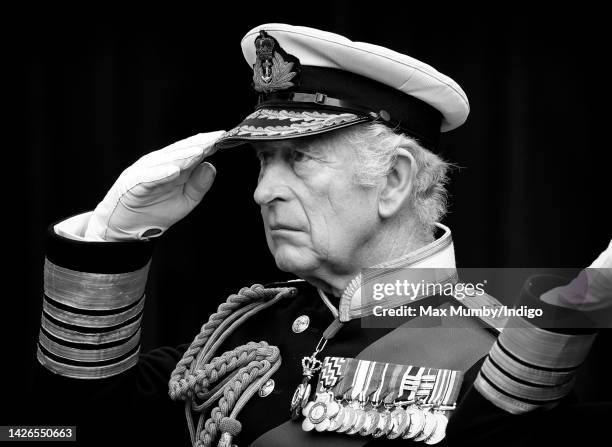King Charles III salutes his mother Queen Elizabeth II's coffin as he attends the Committal Service for Queen Elizabeth II at St George's Chapel,...