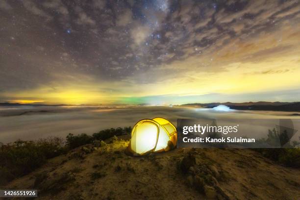 camping tent on mountain with fog and milky way at gunung silipat peak, betong, yala province, thailand - oman landscape stock pictures, royalty-free photos & images