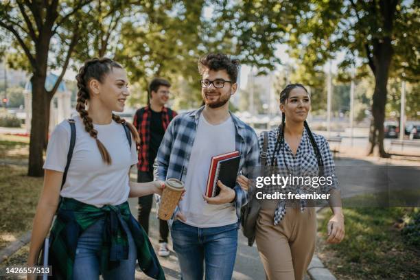 cheerful students walking in campus - international student day stock pictures, royalty-free photos & images