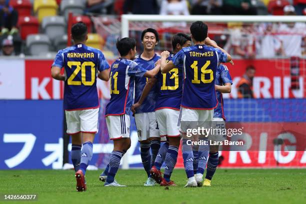 Daichi Kamada of Team Japan celebrates with teammates after scoring their team's first goal during the International Friendly match between Japan and...