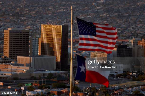 An American and Texas flag are seen flying in front of the skyline of El Paso and Ciudad Juarez on September 23, 2022 in El Paso, Texas. Venezuelans...