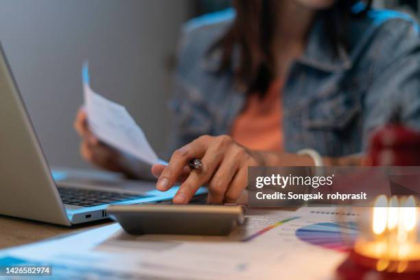 close up of woman planning home budget and using calculator. - tassa foto e immagini stock