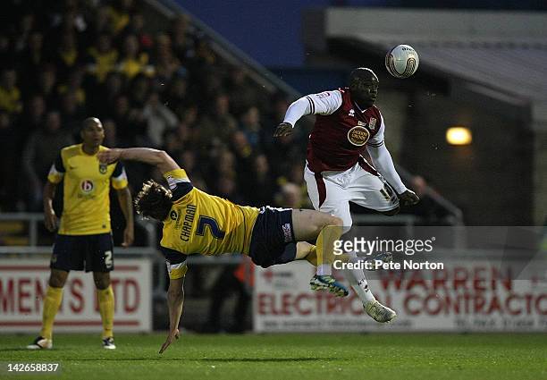 Adebayo Akinfenwa of Northampton Town contests the ball with Adam Chapman of Oxford United during the npower League Two match between Northampton...