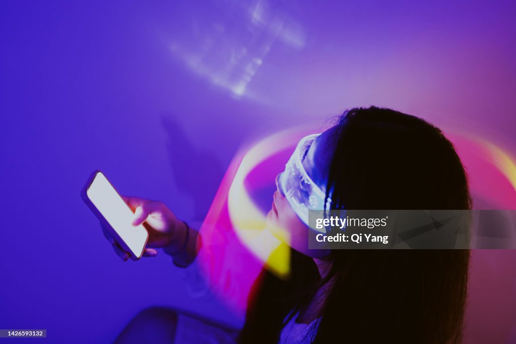 Asian woman using smartphone surrounded by beams of light. Metaverse and Artificial Intelligence