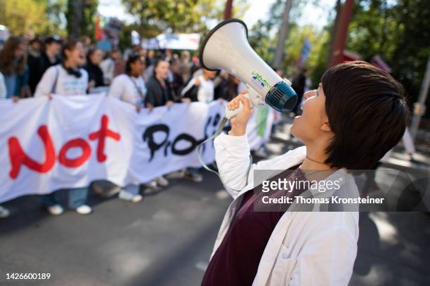 Supporter of the Fridays for Future climate action movement uses a megaphone during a global climate strike on September 23, 2022 in Vienna, Austria....
