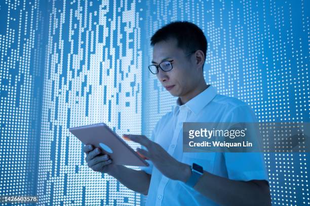 asian man using tablet - chinese businessman stock pictures, royalty-free photos & images