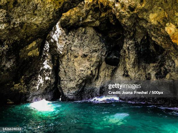scenic view of sea seen through cave,portugal - grotte stock-fotos und bilder