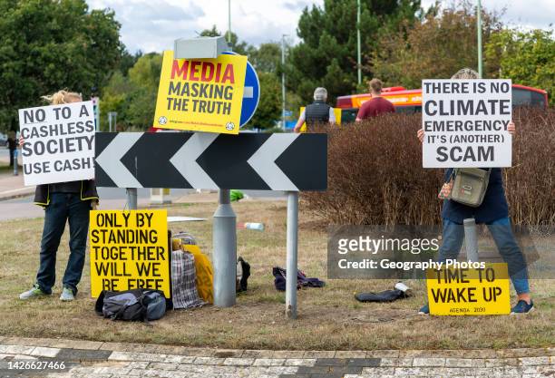 Protest at busy roundabout, Martlesham, Suffolk, England, UK Climate Emergency is a scam, no to cashless society.