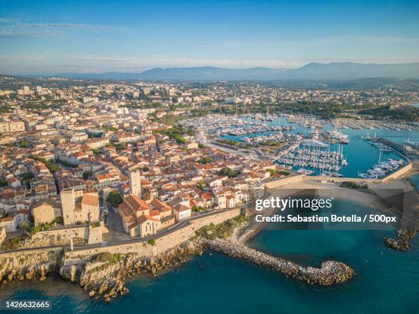 aerial view of cityscape by sea against sky,antibes,france - antibes ストックフォトと画像