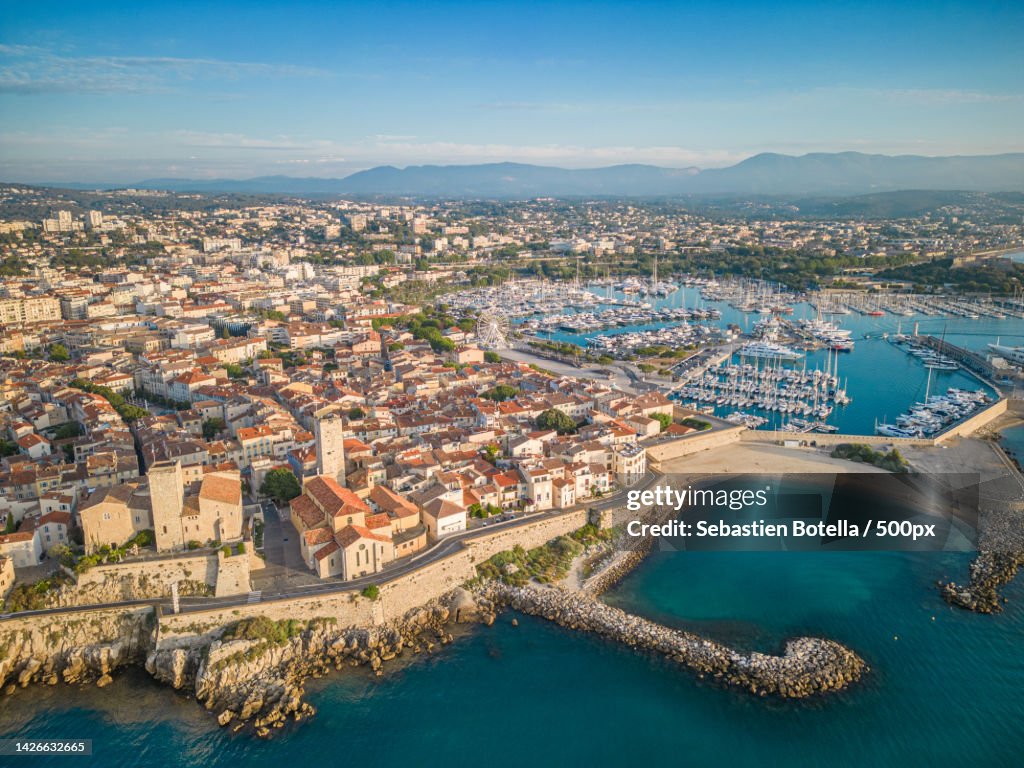 Aerial view of cityscape by sea against sky,Antibes,France