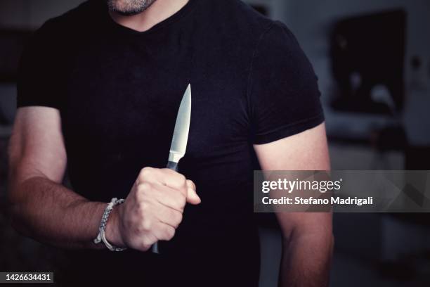 aggression, threatening with a knife in hand - knife crime stock pictures, royalty-free photos & images