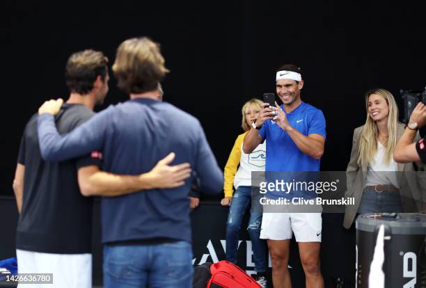 Rafael Nadal of Team Europe takes a photograph of Roger Federer of Team Europe and Carlos Moya, Coach of Rafael Nadal as Maribel Nadal, Sister of...