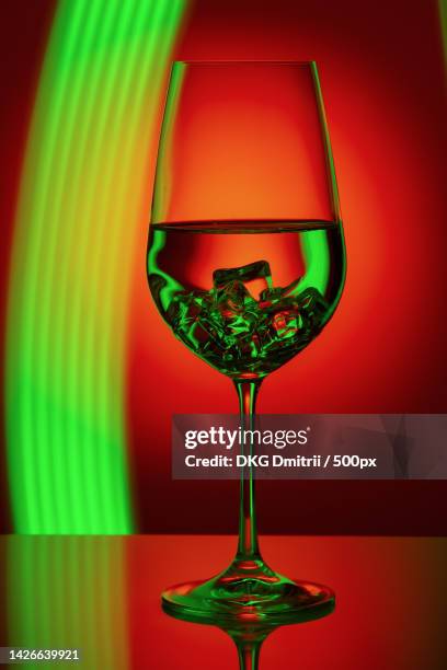 a wine glass with beautiful colorful background light painting macro - goblet cell stock pictures, royalty-free photos & images
