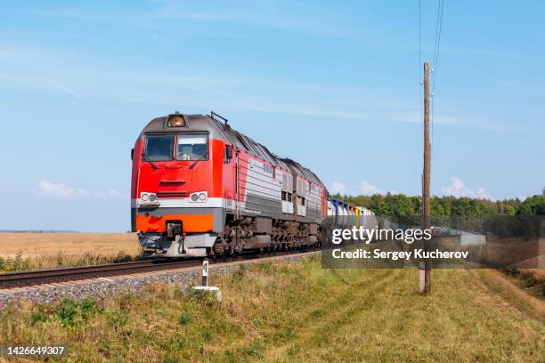 powerful diesel locomotive with freight train - 貨物列車 ストックフォトと画像