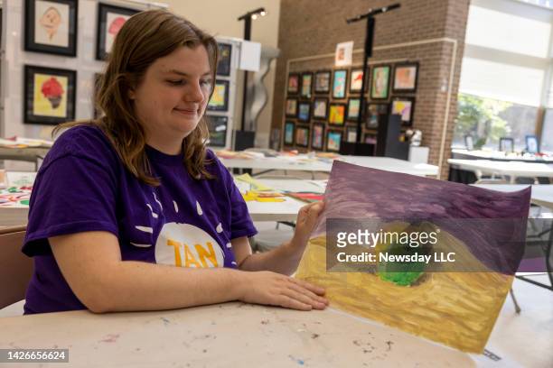 Huntington Station, N.Y.: Kerri Martin shows a painting from the ArtAbility exhibit, that will celebrate inclusion and diversity in the arts by...
