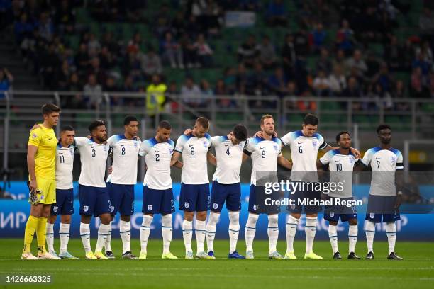 Players of England pause for a moments silence in memory of Her Majesty Queen Elizabeth II, who died away at Balmoral Castle on September 8 prior to...