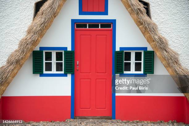 bright and cheery traditional cottage on madeira island, santana village, portugal - blue house red door stock pictures, royalty-free photos & images