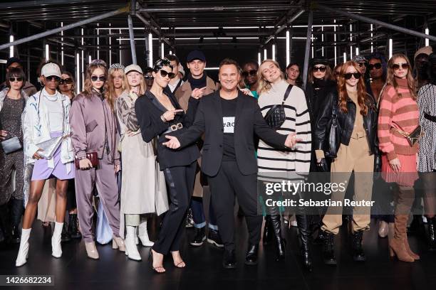 Zoe Helali, Fashion Designer Guido Maria Kretschmer and Kim Hnizdo pose with models after the runway at the Guido Maria Kretschmer show during the...